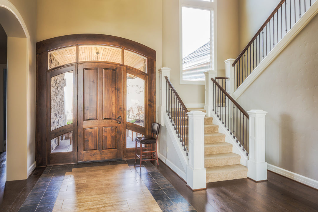 Interior foyer with entry door and side panels